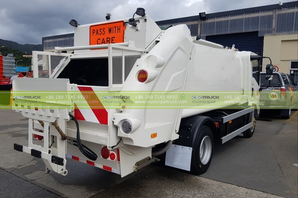 white rear loader compactor garbage truck from back